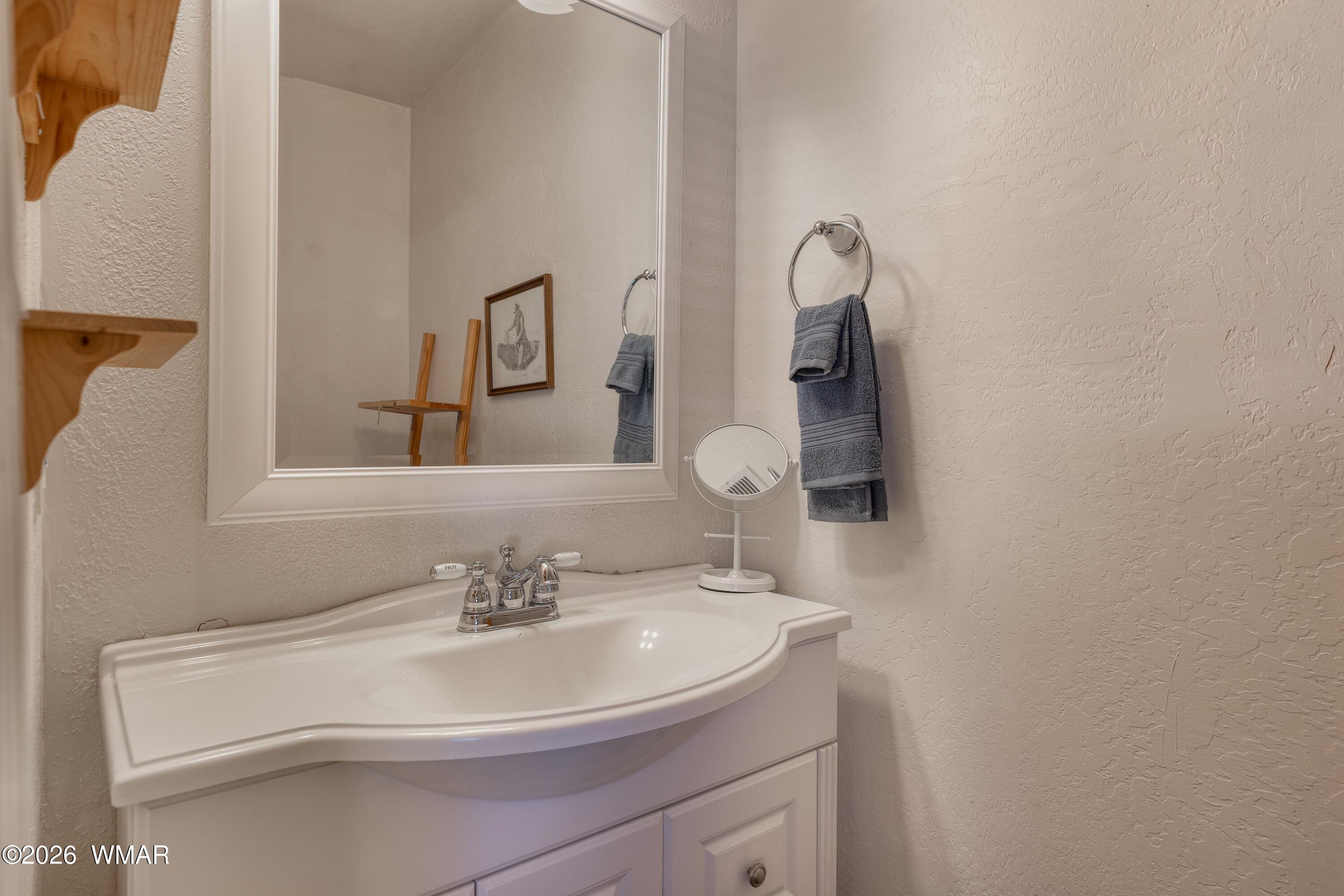 2722 Bain Trail Overgaard, AZ 85933 - Photo 10 of 28 a bathroom with a sink and a mirror
