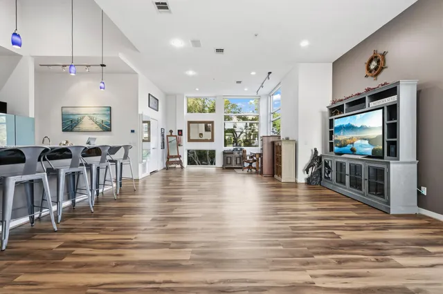 a view of a living room and kitchen with flat screen tv
