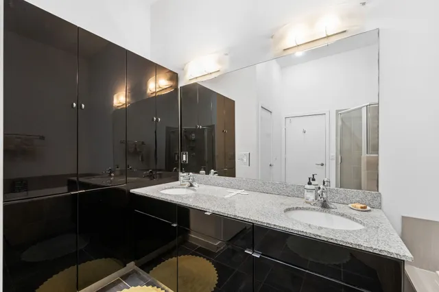 a bathroom with a sink double vanity and a mirror
