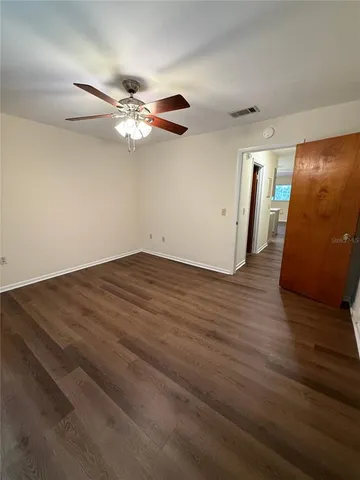 a view of a ceiling fan with wooden floor