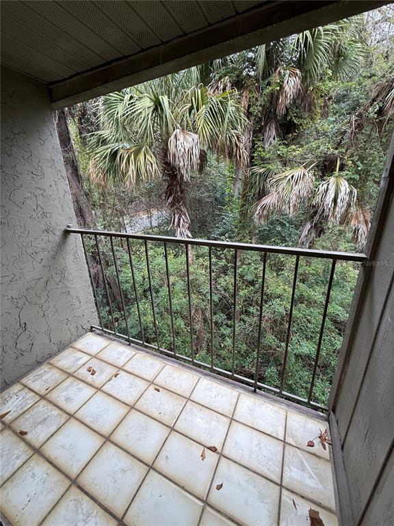 1923 Northwest 23rd Boulevard, Unit 224 Gainesville, FL 32605 - Photo 18 of 20 a balcony with wooden floor