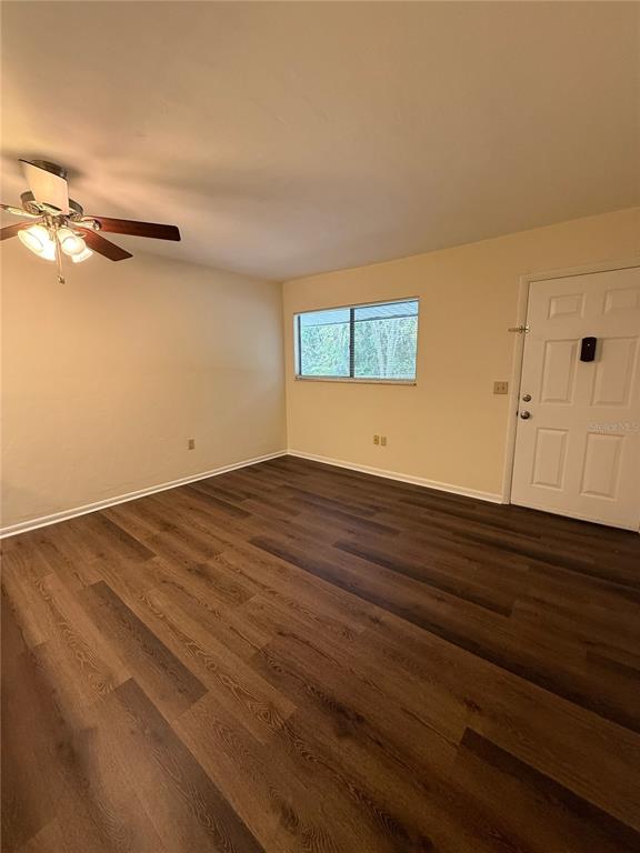 1923 Northwest 23rd Boulevard, Unit 224 Gainesville, FL 32605 - Photo 4 of 20 a view of a room with wooden floor and fan