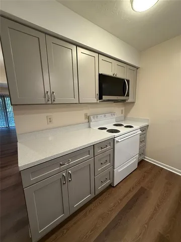 a kitchen with white cabinets stainless steel appliances and sink
