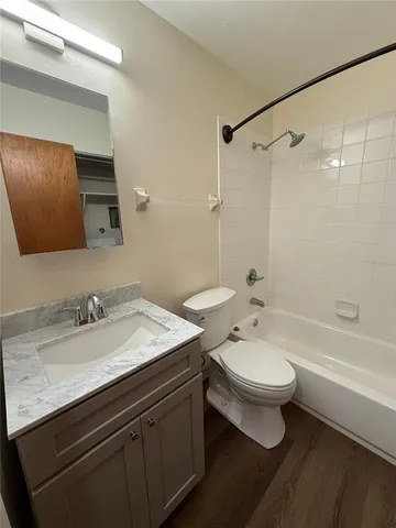a bathroom with a double vanity sink toilet and shower