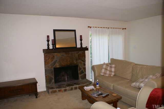 5454 Pine Top Circle Raleigh, NC 27612 - Photo 4 of 10 Another view of living room showing fireplace and door to deck Other