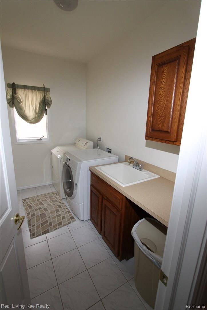 3495 Heron Ridge Drive Rochester, MI 48309 - Photo 17 of 49 CONVENIENT LAUNDRY OFF GARAGE HALL W/LARGE COAT CLOSET