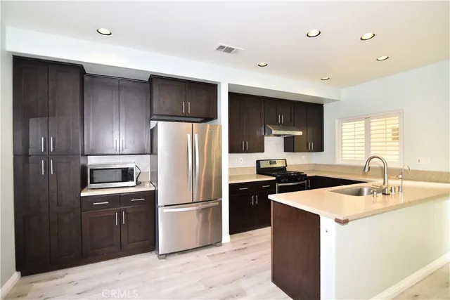a kitchen with a sink and stainless steel appliances