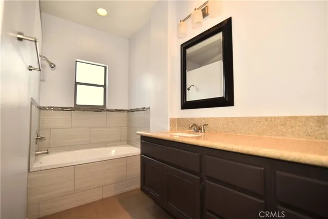 a bathroom with a bathtub and a sink