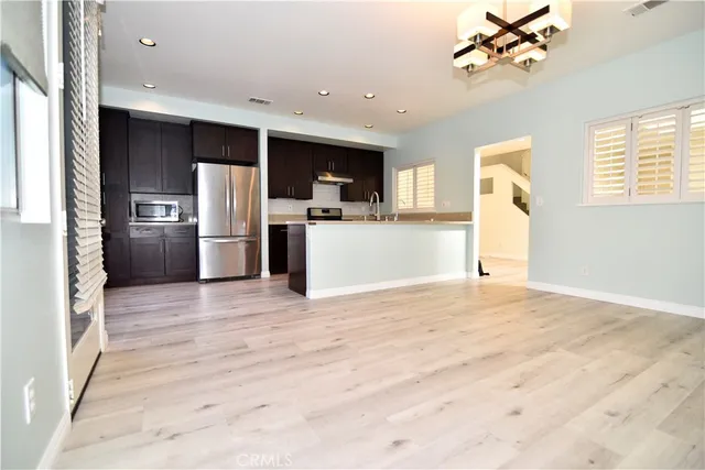 a kitchen with a refrigerator and a sink