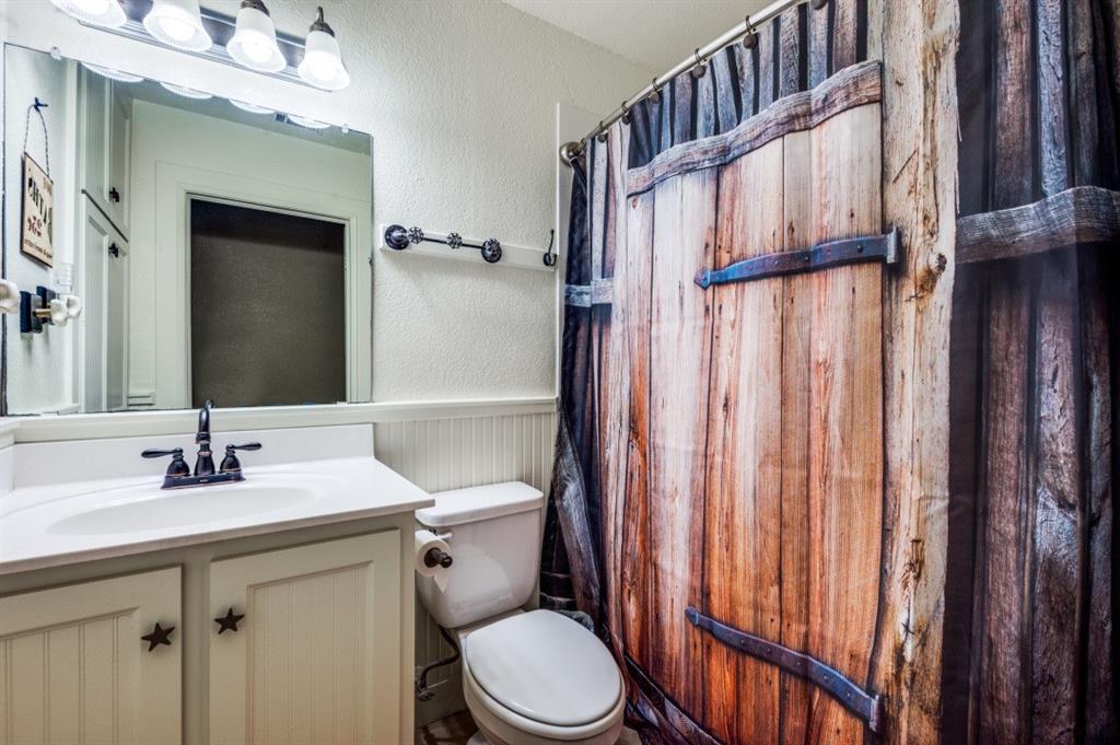 412 North 10th Street Sanger, TX 76266 - Photo 14 of 21 a bathroom with a sink a toilet and shower