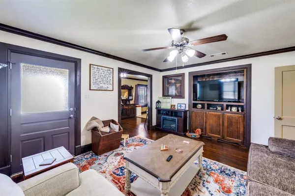 a living room with furniture and a flat screen tv
