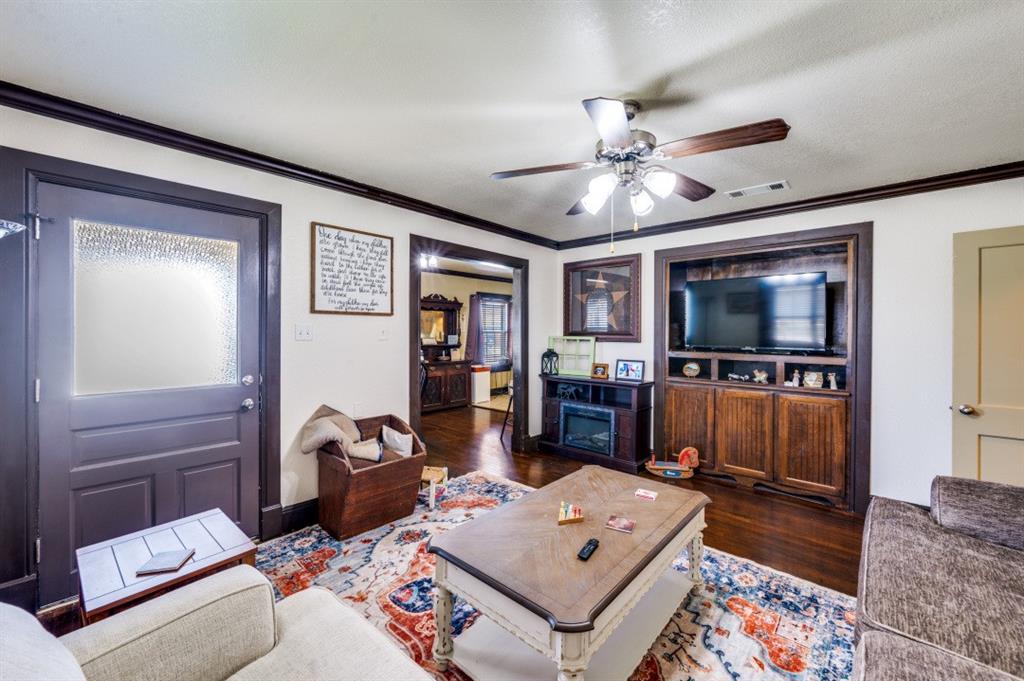 412 North 10th Street Sanger, TX 76266 - Photo 3 of 21 a living room with furniture and a flat screen tv