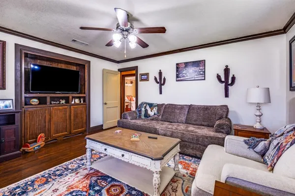 a living room with furniture and a flat screen tv