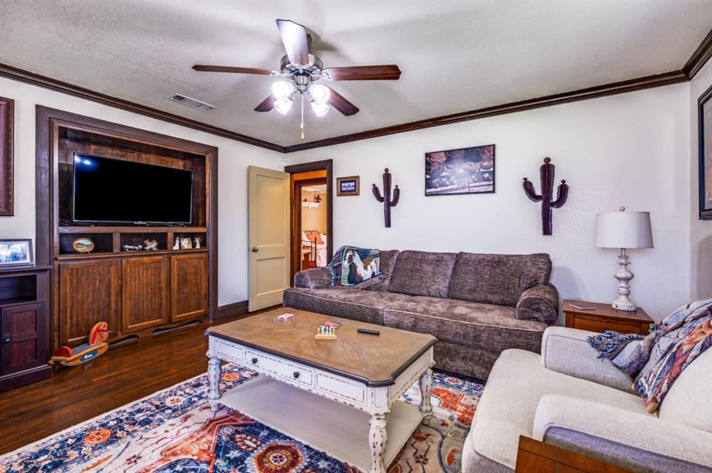 412 North 10th Street Sanger, TX 76266 - Photo 4 of 21 a living room with furniture and a flat screen tv