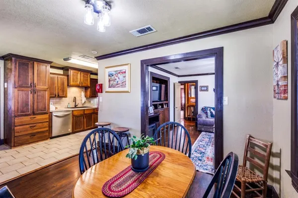 a view of a dining room with furniture a chandelier and wooden floor