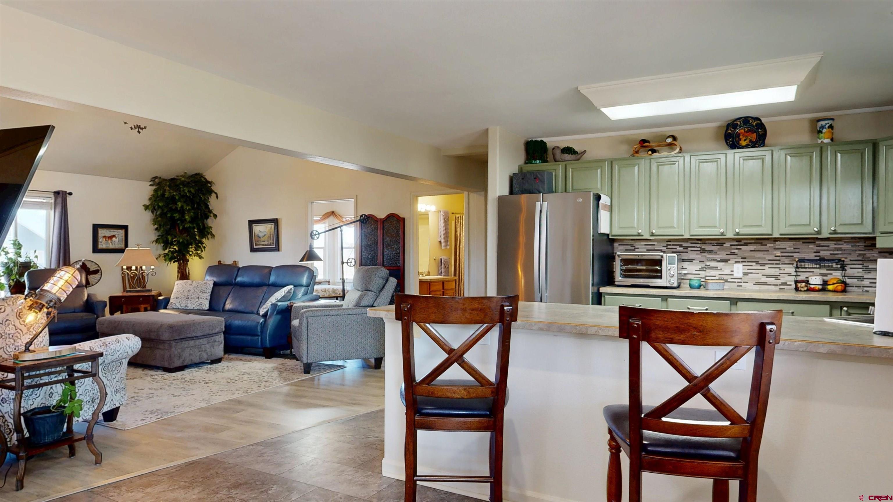 62940 Jeremy Road Montrose, CO 81401 - Photo 11 of 44 a living room with stainless steel appliances kitchen island granite countertop furniture and a view of kitchen