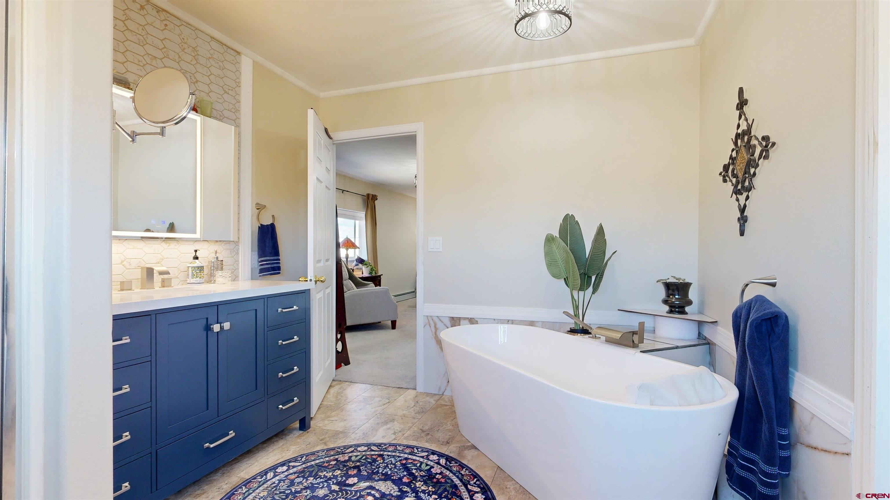 62940 Jeremy Road Montrose, CO 81401 - Photo 14 of 44 a bathroom with a bathtub sink and mirror