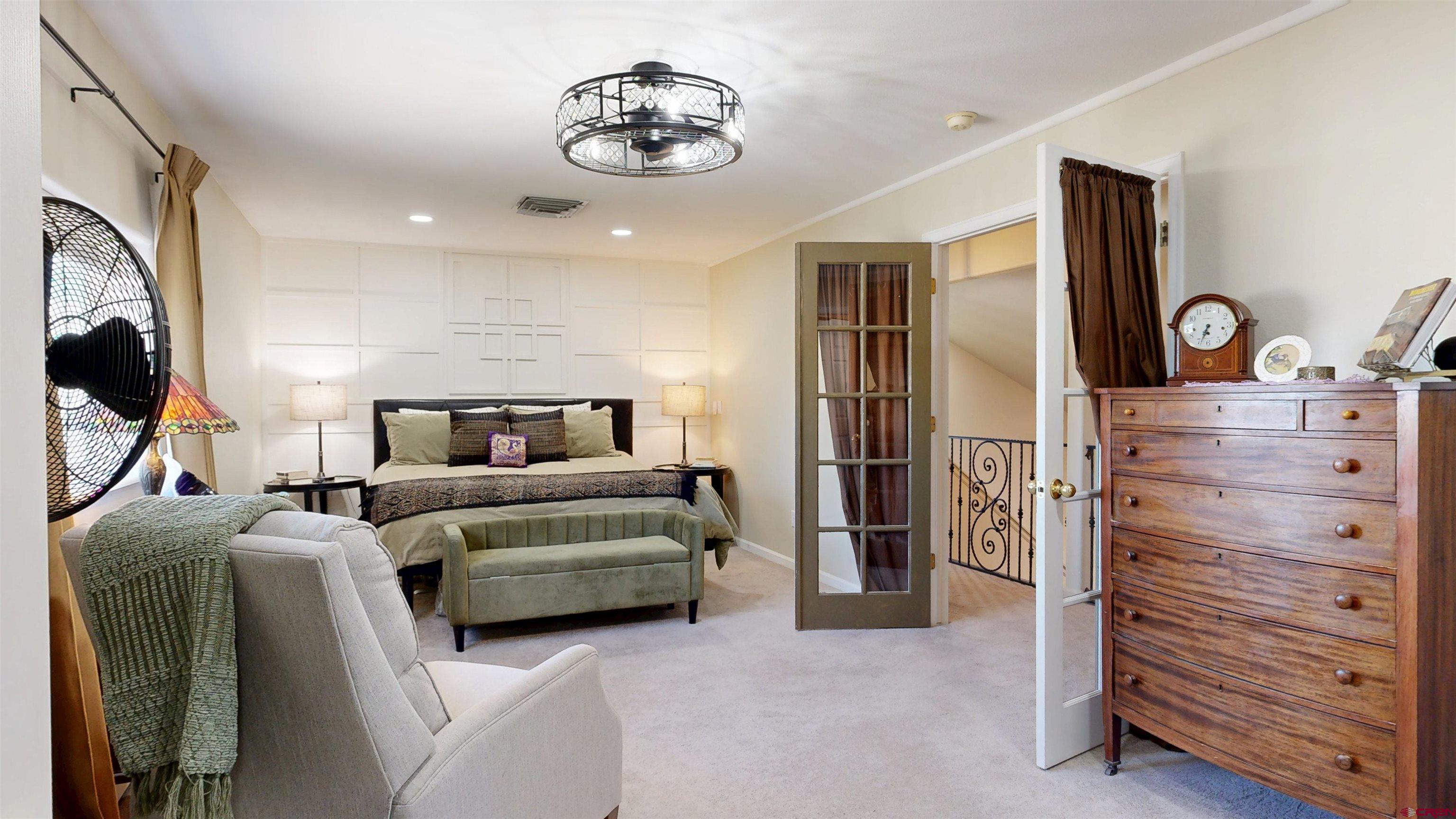 62940 Jeremy Road Montrose, CO 81401 - Photo 17 of 44 a living room with furniture and a flat screen tv