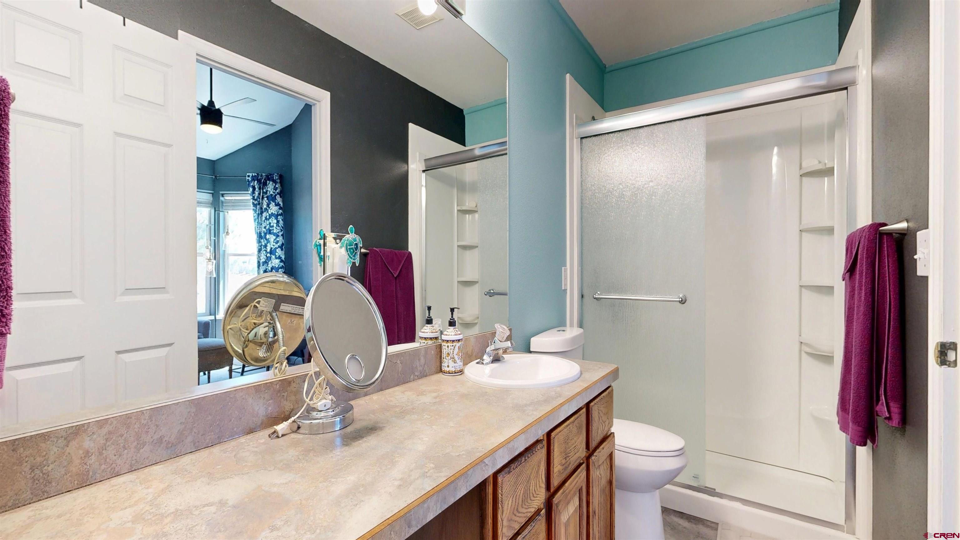 62940 Jeremy Road Montrose, CO 81401 - Photo 23 of 44 a bathroom with a sink vanity mirror and toilet