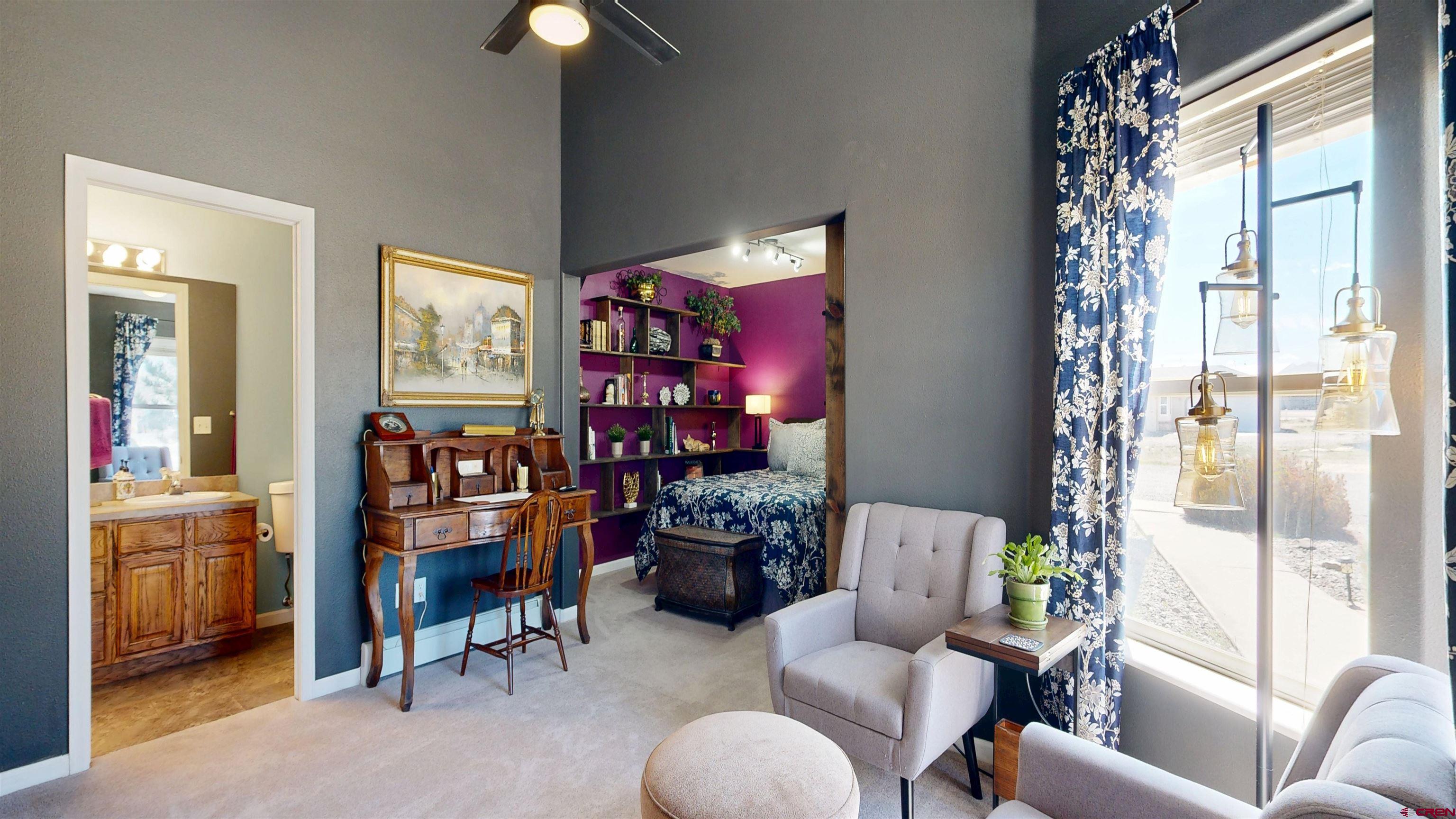 62940 Jeremy Road Montrose, CO 81401 - Photo 25 of 44 a living room with furniture and a chandelier