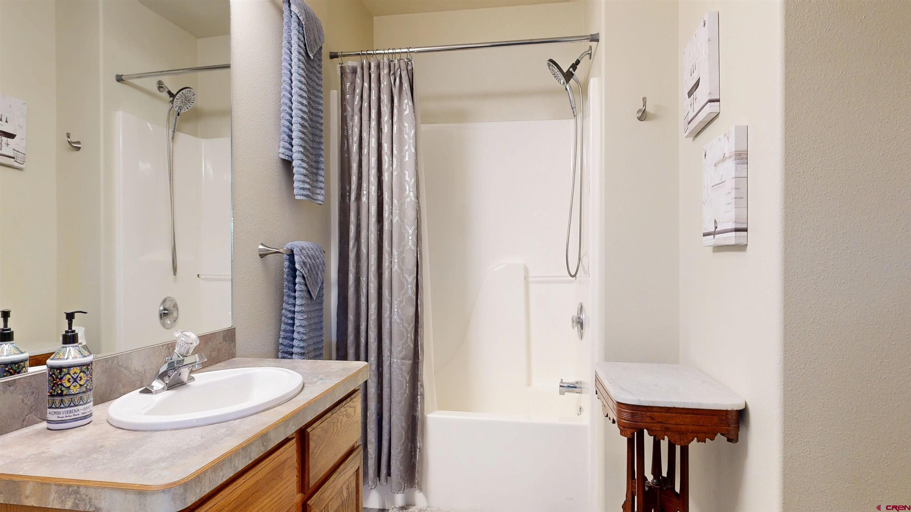 62940 Jeremy Road Montrose, CO 81401 - Photo 27 of 44 a bathroom with a sink vanity granite tub shower and a mirror