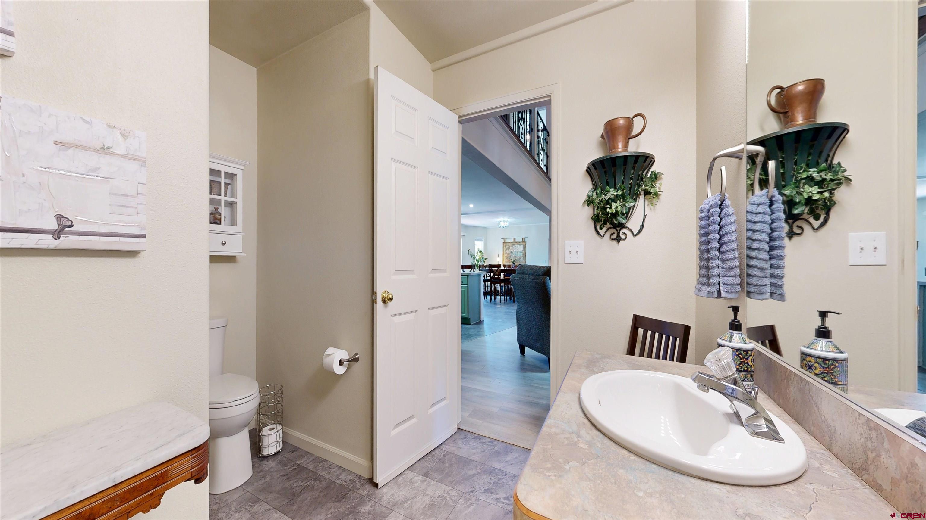 62940 Jeremy Road Montrose, CO 81401 - Photo 28 of 44 a bathroom with a sink a toilet and a mirror