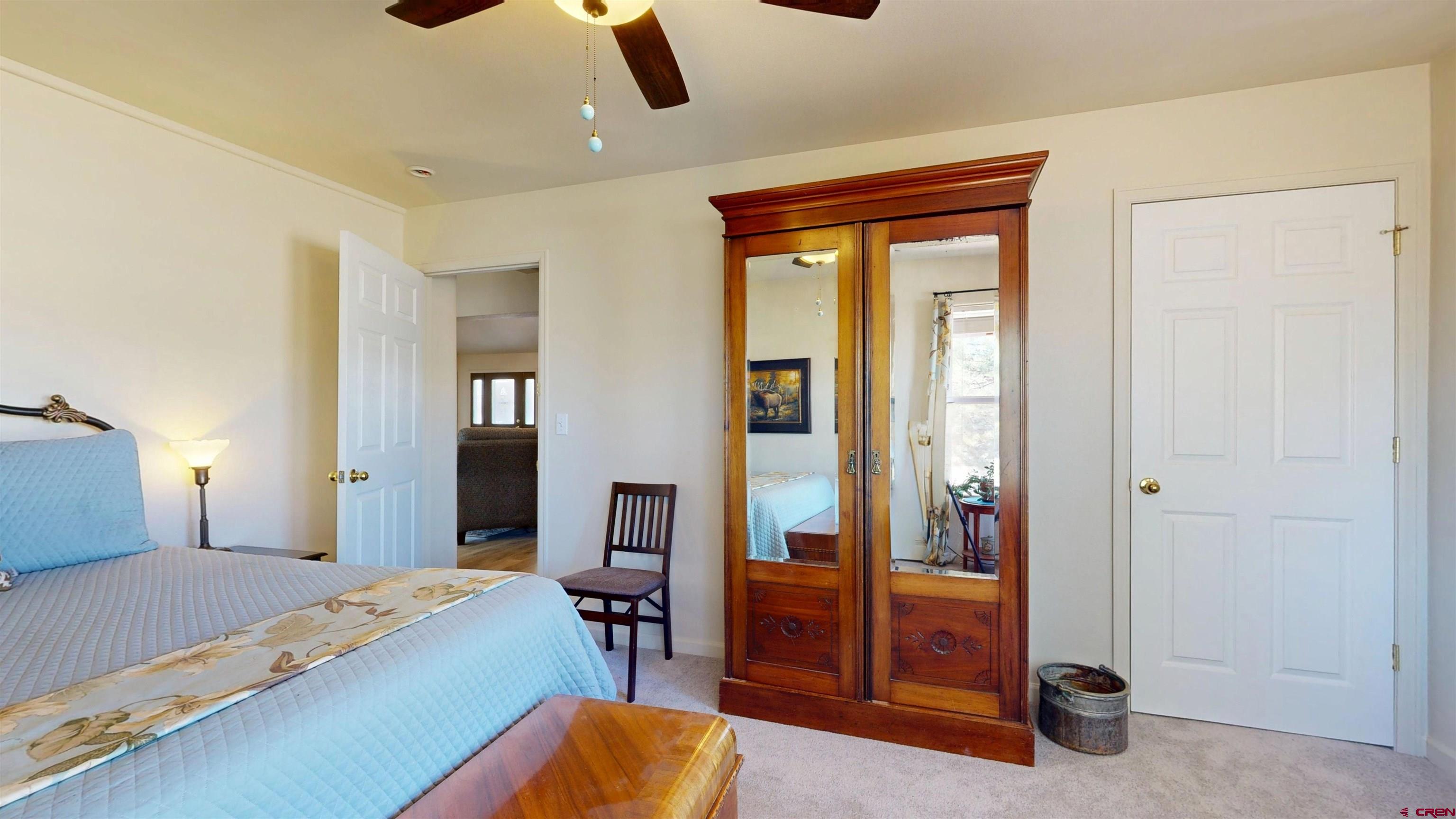 62940 Jeremy Road Montrose, CO 81401 - Photo 30 of 44 a bedroom with a bed and a mirror