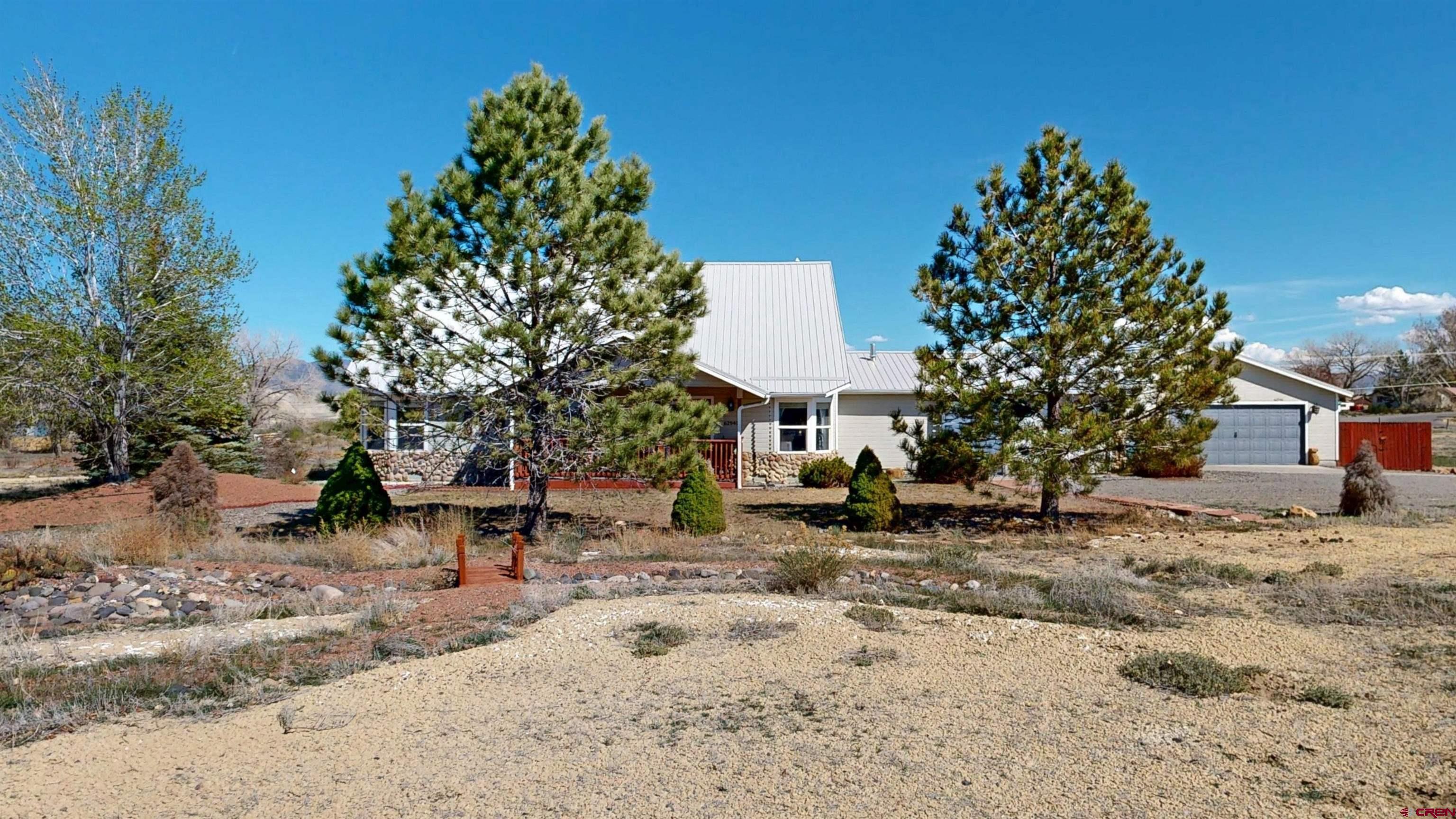 62940 Jeremy Road Montrose, CO 81401 - Photo 3 of 44 a view of a backyard with a tree