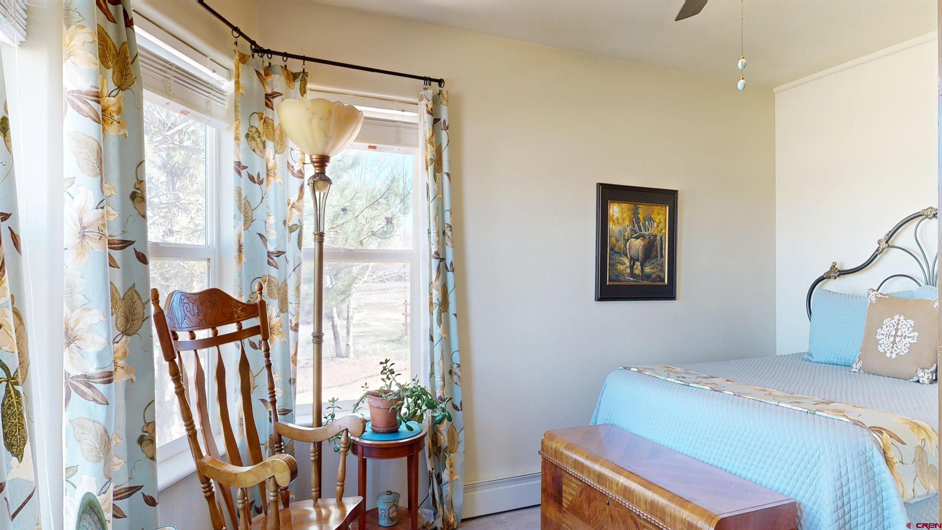 62940 Jeremy Road Montrose, CO 81401 - Photo 31 of 44 a bedroom with a bed and a chair