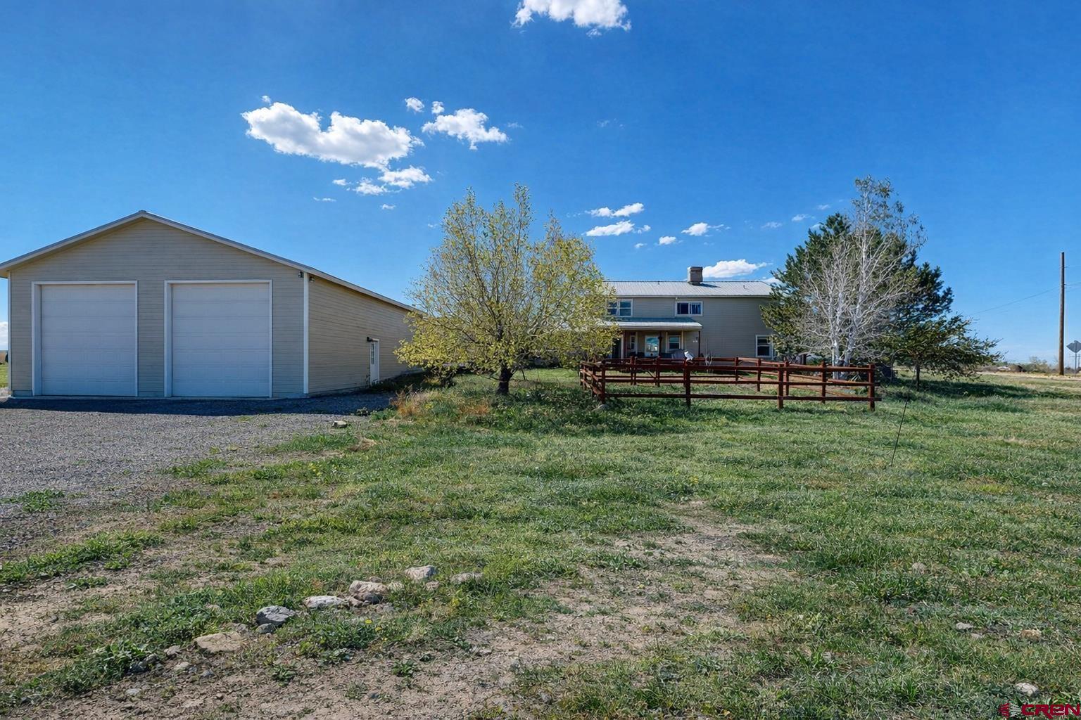 62940 Jeremy Road Montrose, CO 81401 - Photo 41 of 44 a view of a house with a yard and a garage
