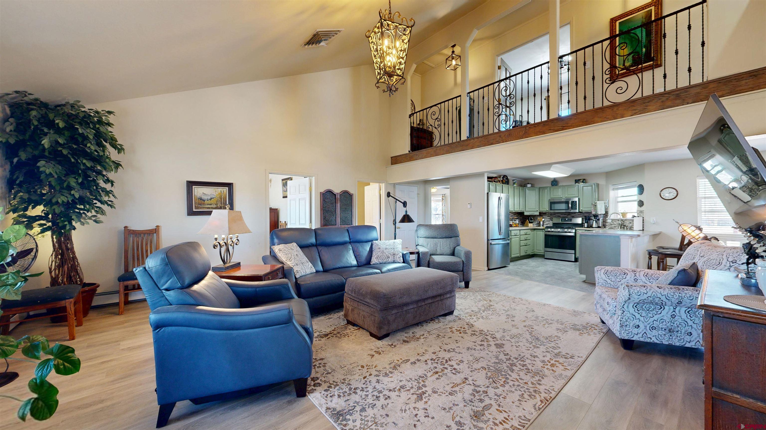 62940 Jeremy Road Montrose, CO 81401 - Photo 5 of 44 a living room with furniture ceiling fan and a rug