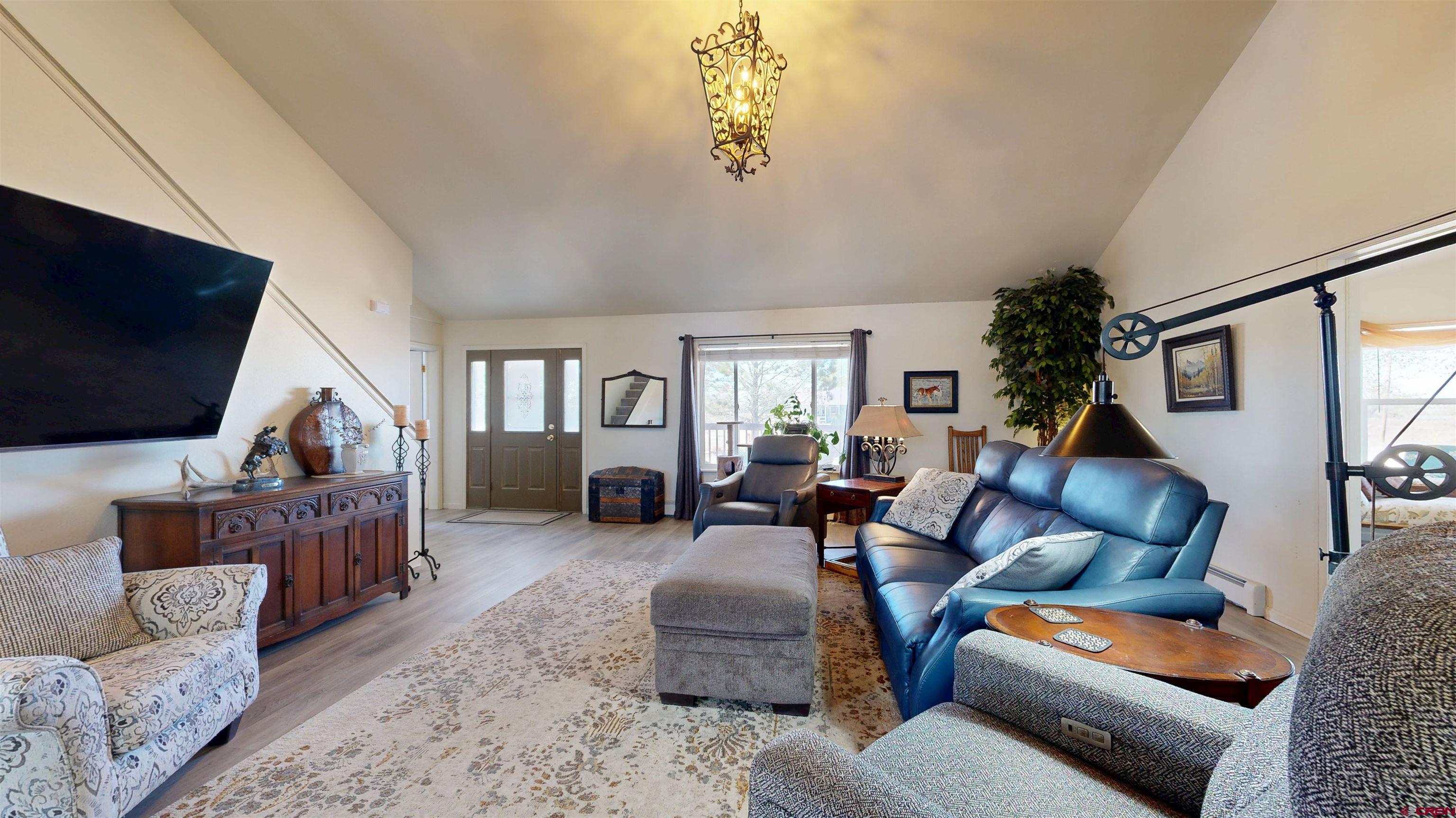 62940 Jeremy Road Montrose, CO 81401 - Photo 6 of 44 a living room with furniture and a flat screen tv