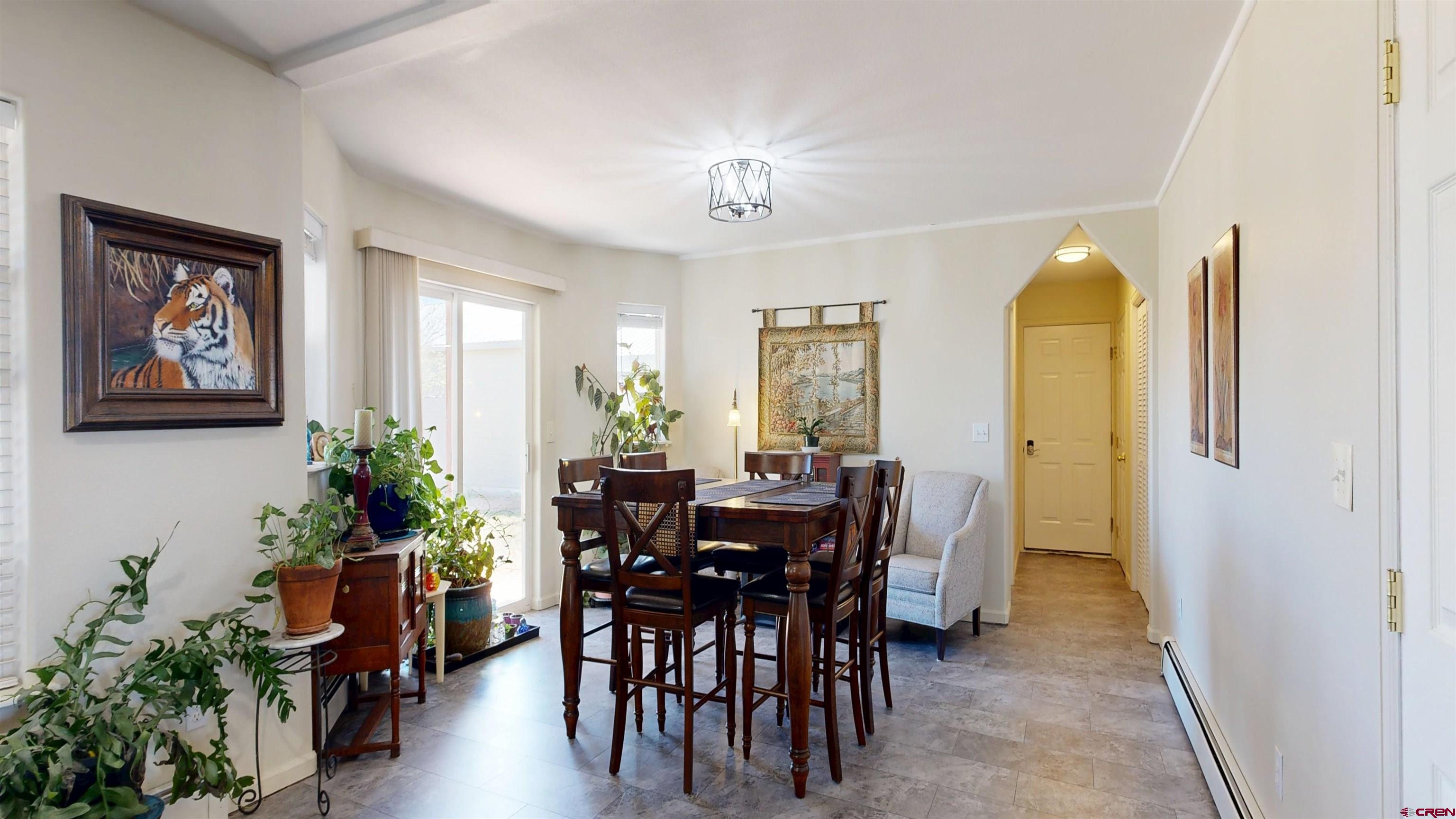 62940 Jeremy Road Montrose, CO 81401 - Photo 9 of 44 a view of a dining room with furniture and a potted plant