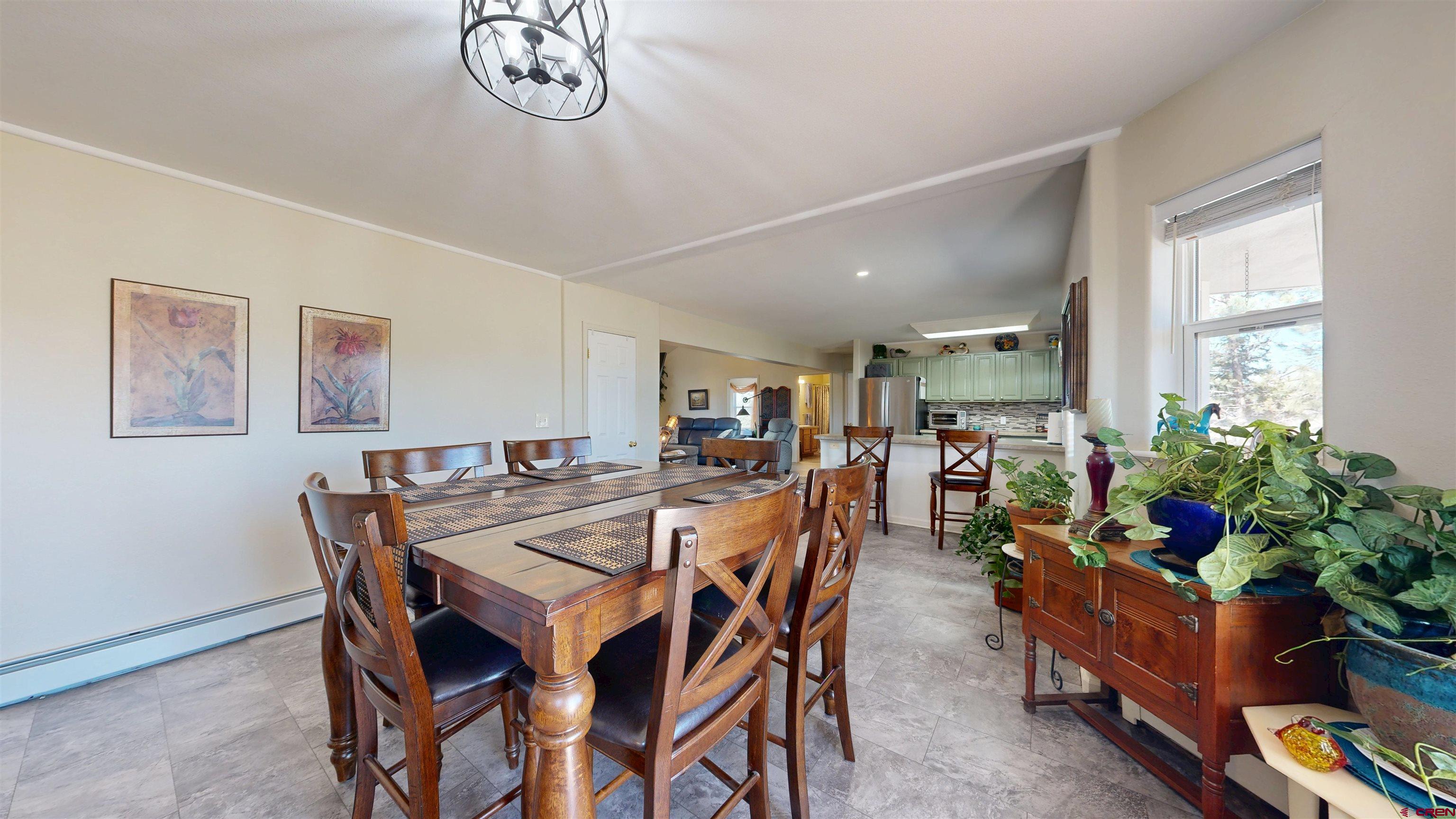 62940 Jeremy Road Montrose, CO 81401 - Photo 10 of 44 a view of a dining room with furniture and a potted plant