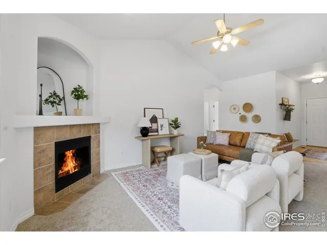 a living room with furniture and a fireplace
