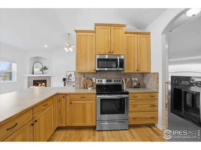 a kitchen with stainless steel appliances a stove sink microwave and cabinets