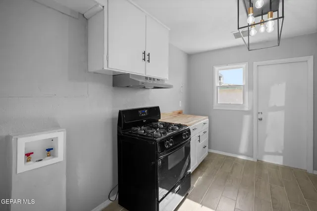 a kitchen with stainless steel appliances granite countertop a stove and a refrigerator