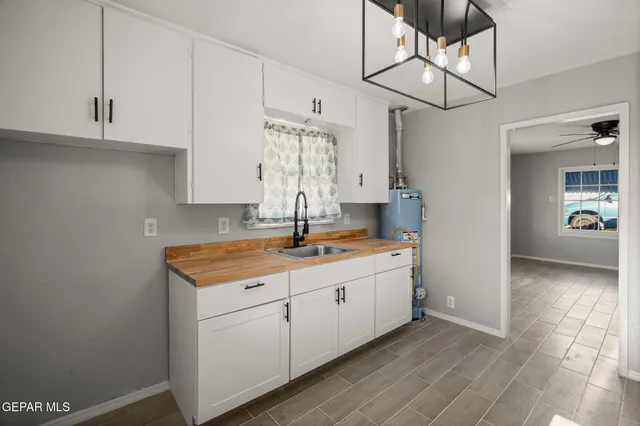 a kitchen with stainless steel appliances granite countertop a sink and dishwasher with white cabinets