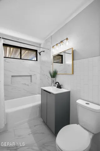 a bathroom with a toilet a sink and bathtub