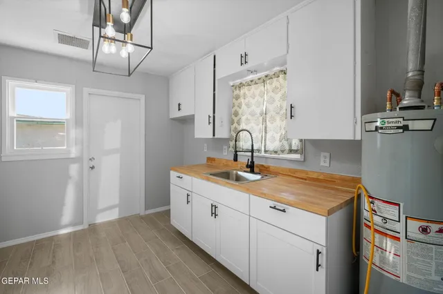a kitchen with a sink cabinets and wooden floor
