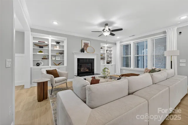 a kitchen with stainless steel appliances kitchen island granite countertop a table chairs sink and cabinets