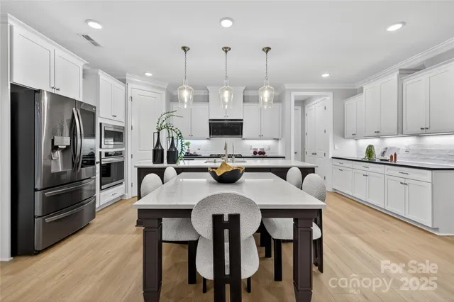 a spacious bedroom with a bed and a chandelier