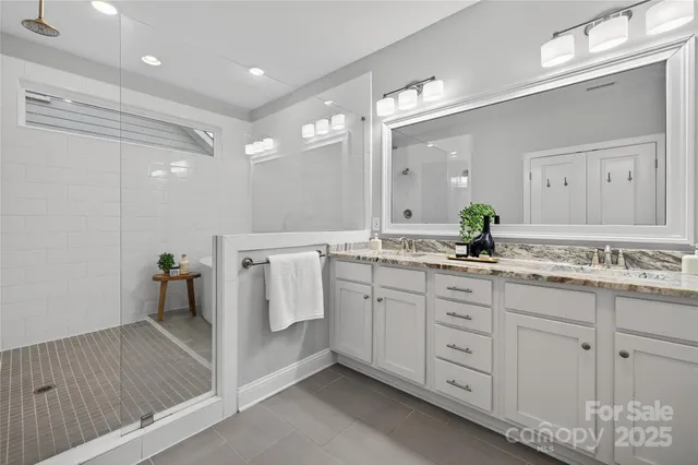 an aerial view of a house with a yard and lake view