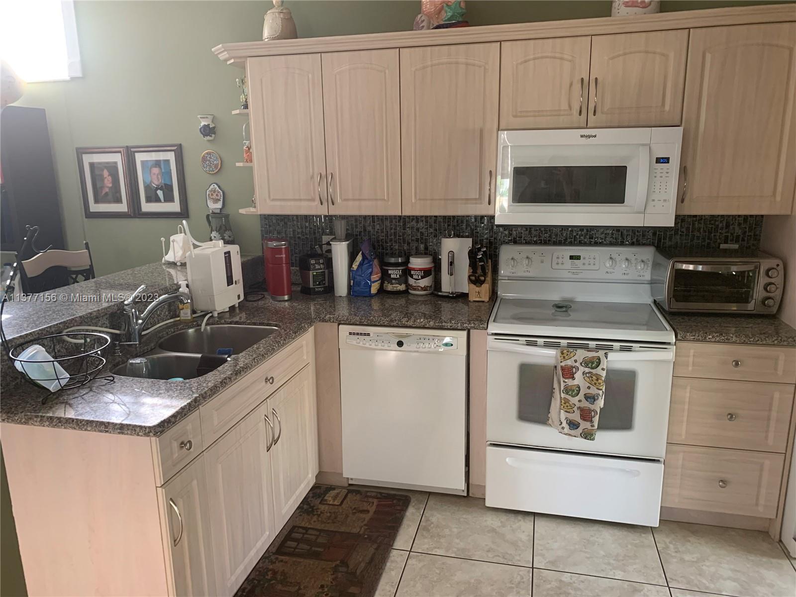 Emerald Hills Hollywood, FL 33021 - Photo 3 of 12 a kitchen with a sink and cabinets