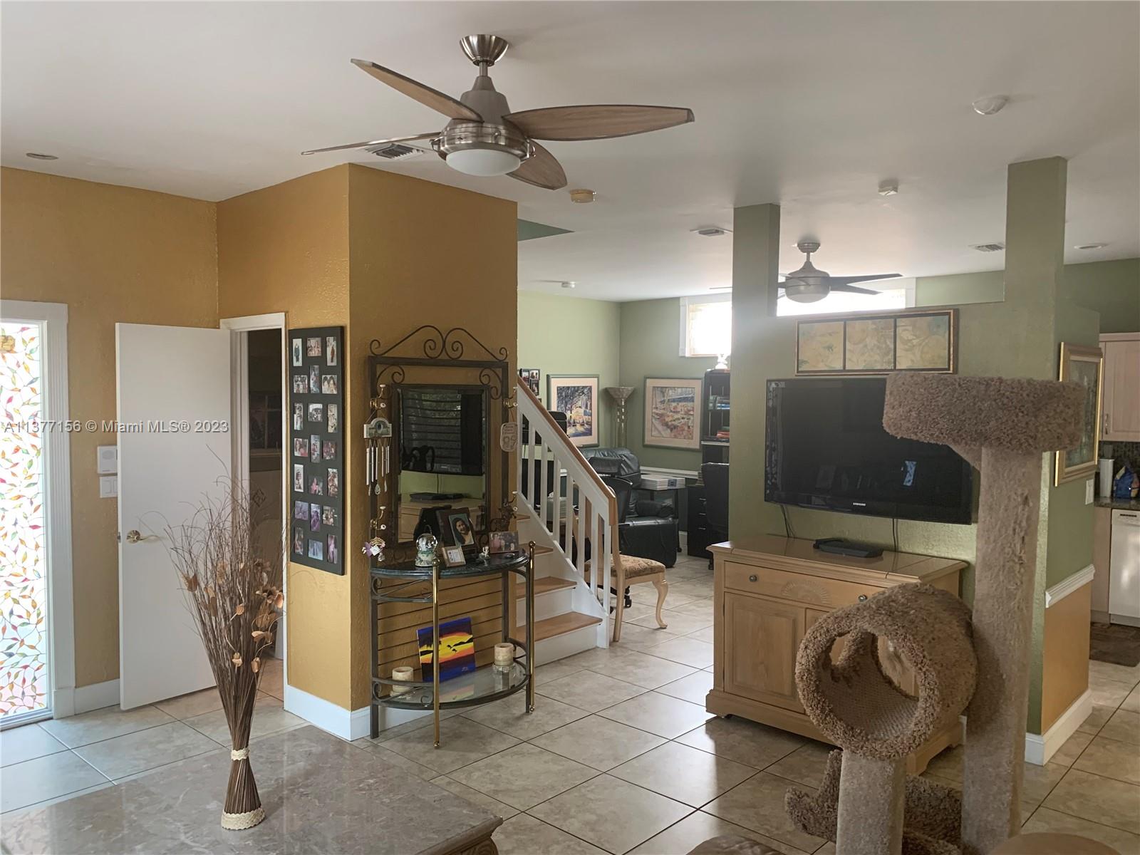 Emerald Hills Hollywood, FL 33021 - Photo 5 of 12 a view of a livingroom with furniture and a flat screen tv
