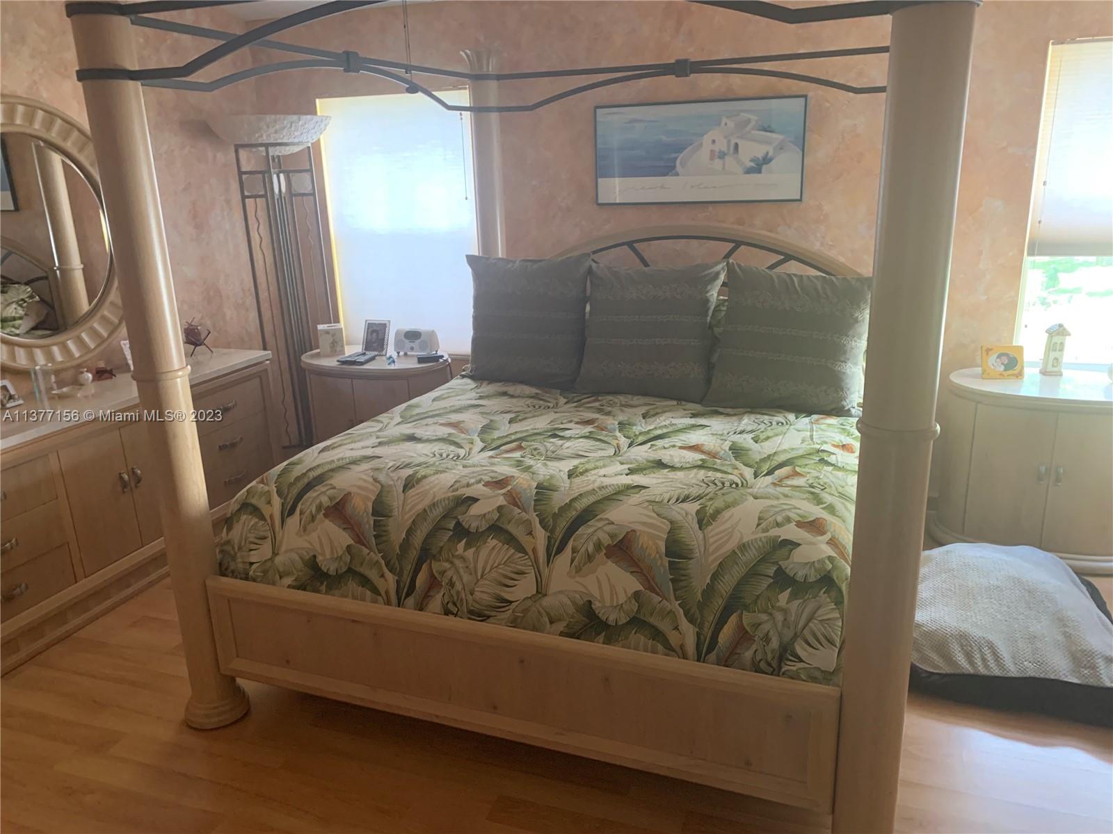 Emerald Hills Hollywood, FL 33021 - Photo 8 of 12 a bedroom with a bed and wooden floor