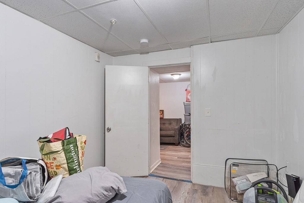 40 Aetna Street Worcester, MA 01604 - Photo 12 of 42 a bedroom with a bed and a chandelier