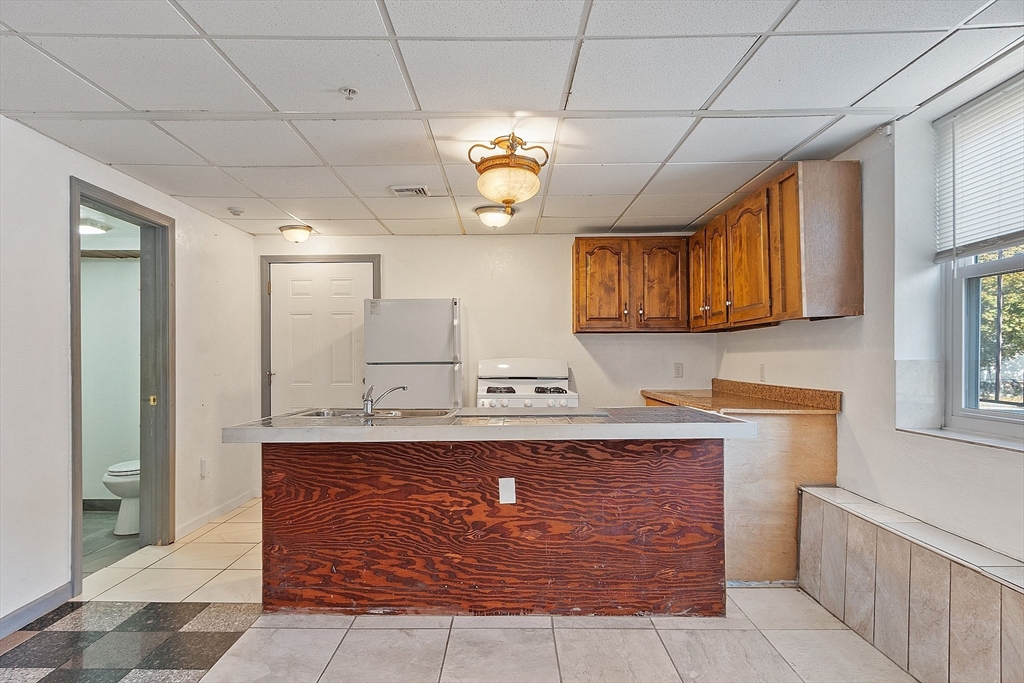 40 Aetna Street Worcester, MA 01604 - Photo 15 of 42 a kitchen with stainless steel appliances granite countertop a sink stove and cabinets