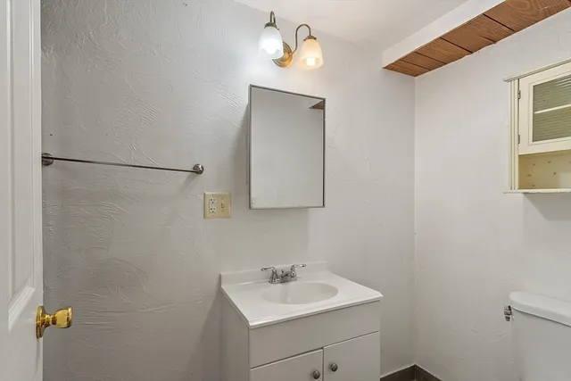 a bathroom with a sink a mirror and a shower