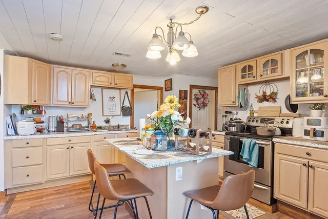 a kitchen with stainless steel appliances kitchen island granite countertop a sink and cabinets